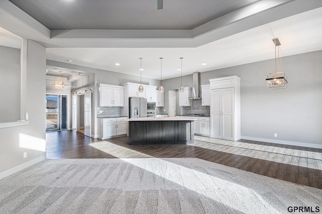 kitchen with white cabinetry, open floor plan, tasteful backsplash, and stainless steel fridge