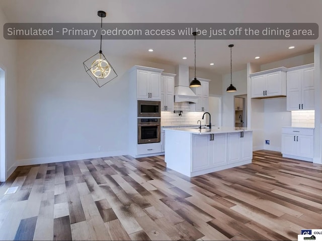 kitchen with custom exhaust hood, light wood-style flooring, stainless steel appliances, light countertops, and white cabinetry