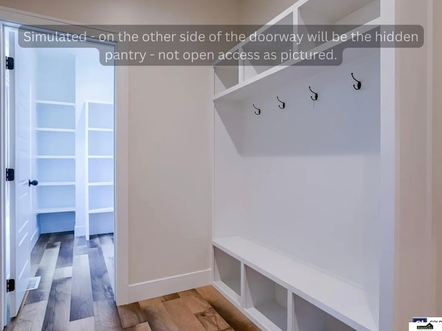 mudroom featuring baseboards and wood finished floors