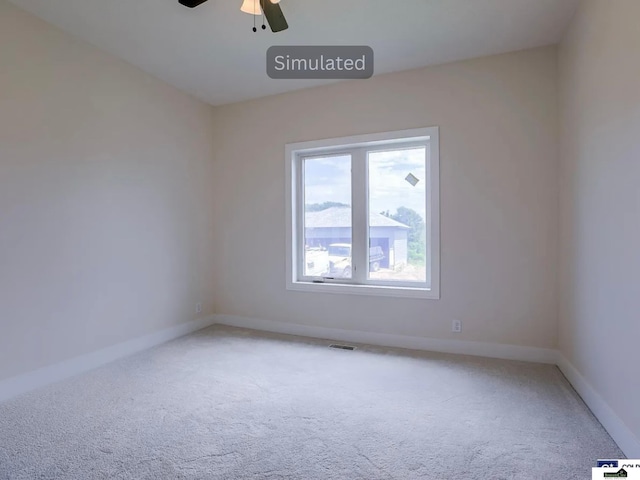 unfurnished room featuring baseboards, carpet, visible vents, and ceiling fan