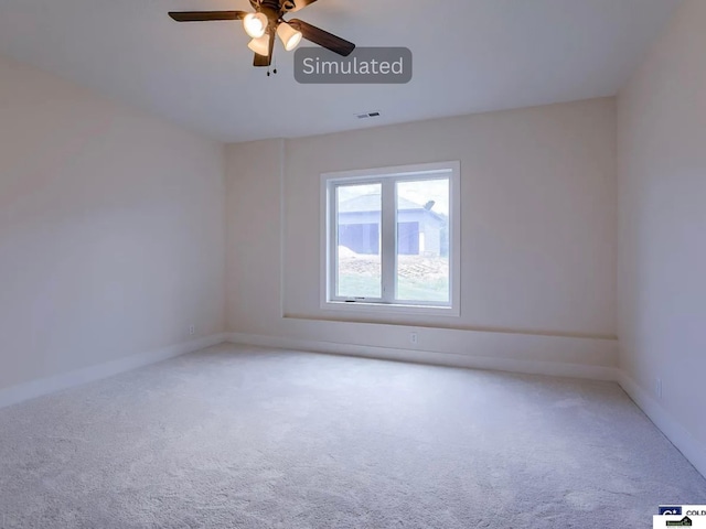 spare room with ceiling fan, baseboards, visible vents, and light carpet