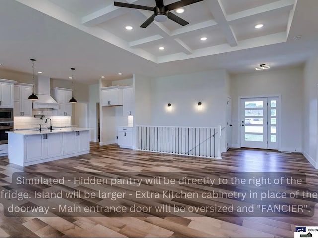 kitchen with beam ceiling, decorative backsplash, a towering ceiling, custom exhaust hood, and stainless steel appliances