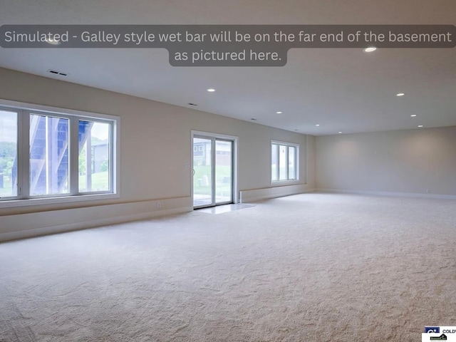 carpeted empty room with recessed lighting, visible vents, and baseboards