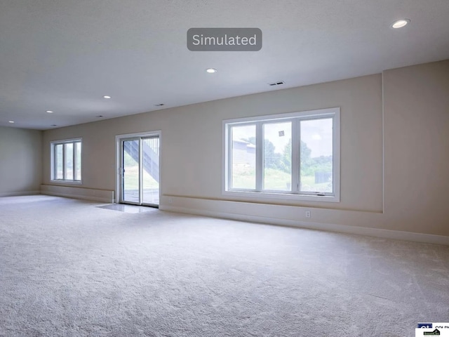 carpeted empty room featuring visible vents, recessed lighting, and baseboards