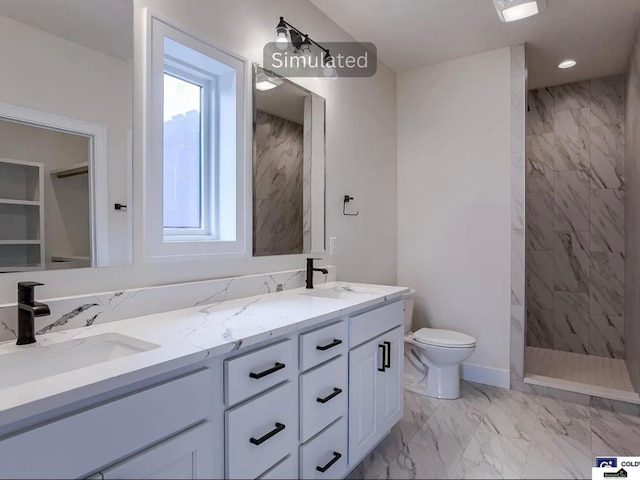 bathroom with toilet, marble finish floor, a sink, double vanity, and tiled shower