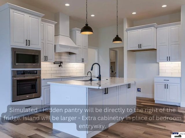 kitchen featuring decorative light fixtures, stainless steel appliances, custom exhaust hood, and white cabinets