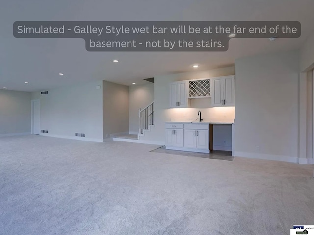 unfurnished living room featuring visible vents, light carpet, recessed lighting, stairway, and wet bar