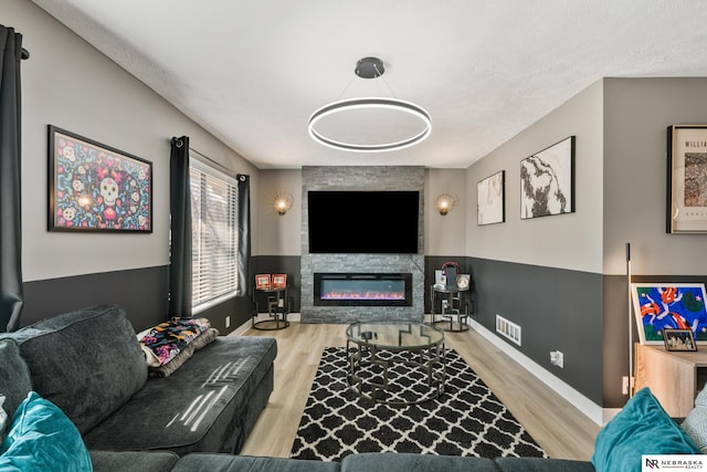 10230 Weir St, Ralston, NE 68127 - living room with a fireplace, wood finished floors, visible vents, and wainscoting