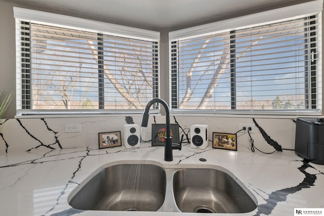 10230 Weir St, Ralston, NE 68127 - room details featuring a sink and light stone countertops