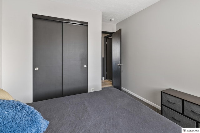 10230 Weir St, Ralston, NE 68127 - bedroom featuring baseboards, a closet, carpet floors, and a textured ceiling