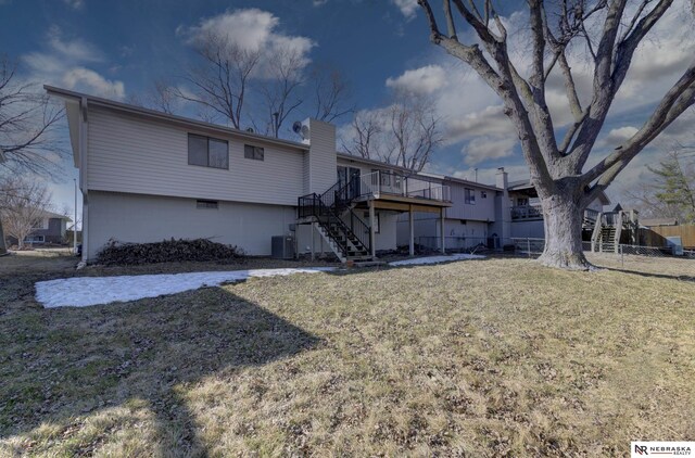 10230 Weir St, Ralston, NE 68127 - rear view of house featuring fence, stairway, a wooden deck, central AC, and a lawn