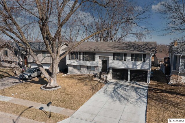 10230 Weir St, Ralston, NE 68127 - raised ranch with concrete driveway, an attached garage, and roof with shingles