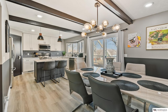 10230 Weir St, Ralston, NE 68127 - dining area with a notable chandelier, beamed ceiling, light wood-style flooring, and recessed lighting