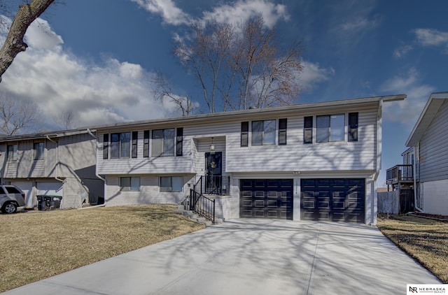 10230 Weir St, Ralston, NE 68127 - bi-level home featuring a garage, concrete driveway, and a front yard