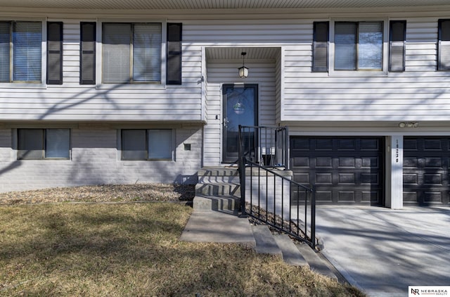 10230 Weir St, Ralston, NE 68127 - doorway to property with driveway and a garage