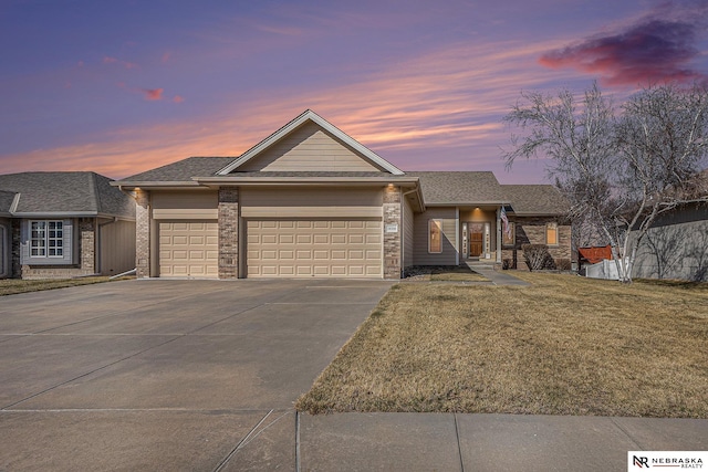 view of front facade featuring an attached garage, driveway, and a front lawn