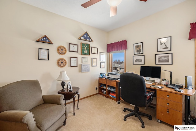 office featuring baseboards, light carpet, and ceiling fan