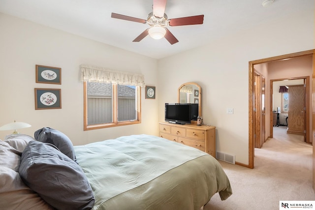 bedroom featuring visible vents, light carpet, baseboards, and a ceiling fan