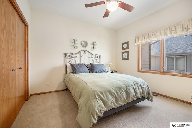 bedroom featuring a closet, baseboards, carpet floors, and ceiling fan