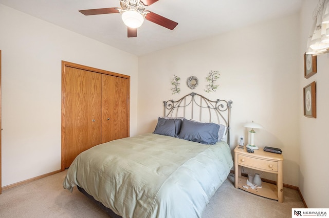 carpeted bedroom featuring a closet, baseboards, and ceiling fan