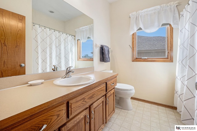 full bath with vanity, tile patterned floors, toilet, and baseboards