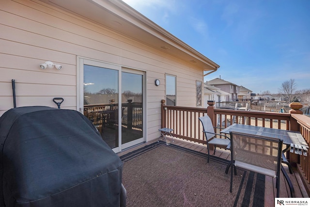 view of patio with a residential view, a wooden deck, and outdoor dining area