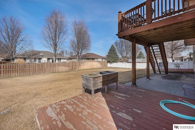 deck featuring a patio, stairway, a yard, and fence