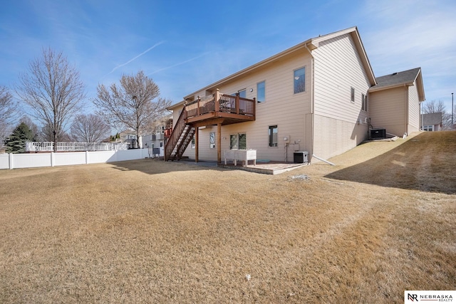 rear view of property featuring fence, a wooden deck, stairs, central air condition unit, and a patio area