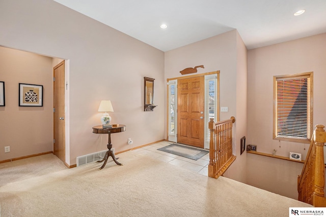 carpeted foyer featuring tile patterned floors, recessed lighting, visible vents, and baseboards