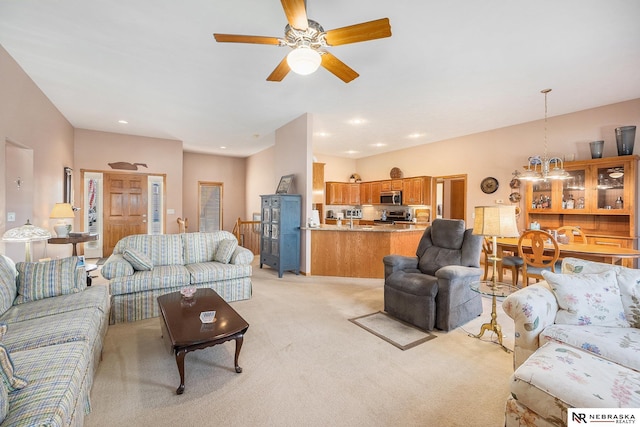 living area featuring recessed lighting, light colored carpet, and ceiling fan