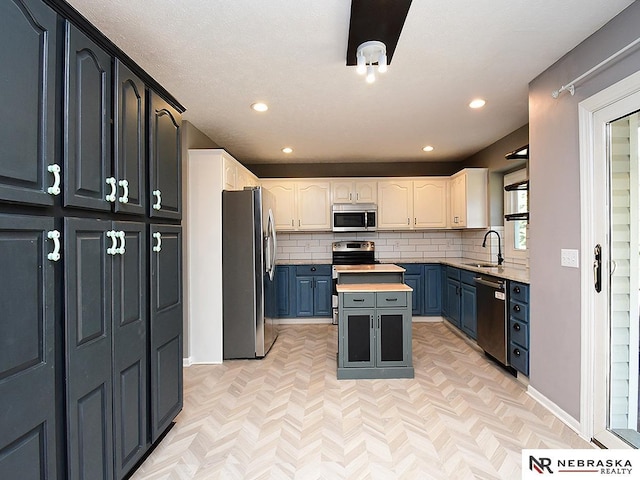 kitchen with tasteful backsplash, recessed lighting, appliances with stainless steel finishes, and a sink