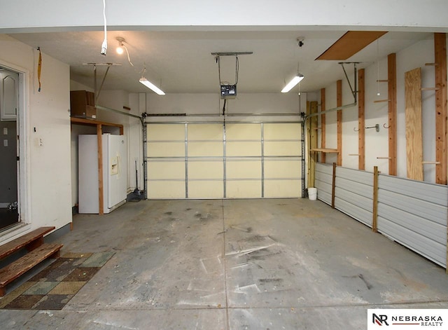 garage with white refrigerator with ice dispenser and a garage door opener