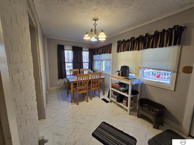 dining room with a textured ceiling, marble finish floor, a chandelier, and crown molding