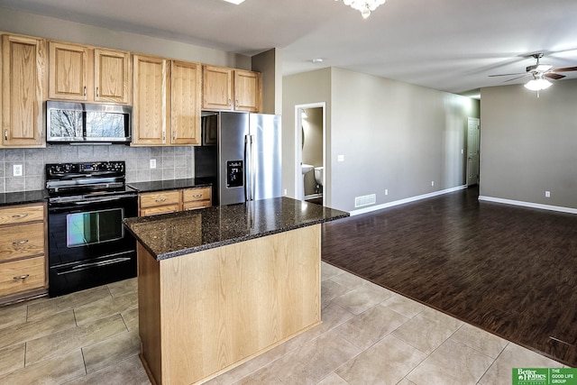 kitchen featuring ceiling fan, light tile patterned floors, backsplash, and stainless steel appliances