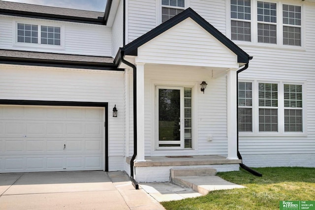 doorway to property with driveway and an attached garage