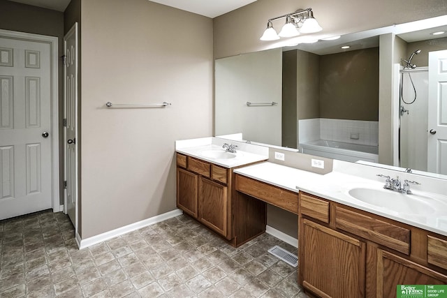 full bathroom with visible vents, baseboards, walk in shower, a garden tub, and vanity