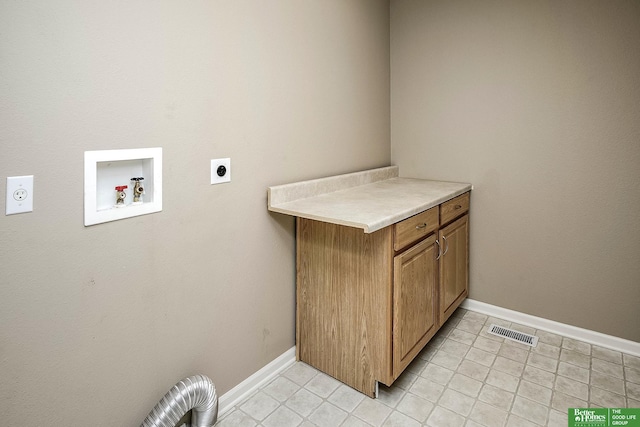 clothes washing area with visible vents, baseboards, washer hookup, cabinet space, and electric dryer hookup