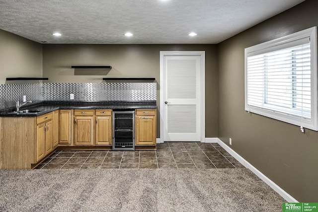 kitchen with a sink, baseboards, wine cooler, decorative backsplash, and open shelves