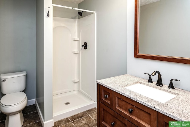 full bathroom with toilet, a stall shower, vanity, and tile patterned flooring