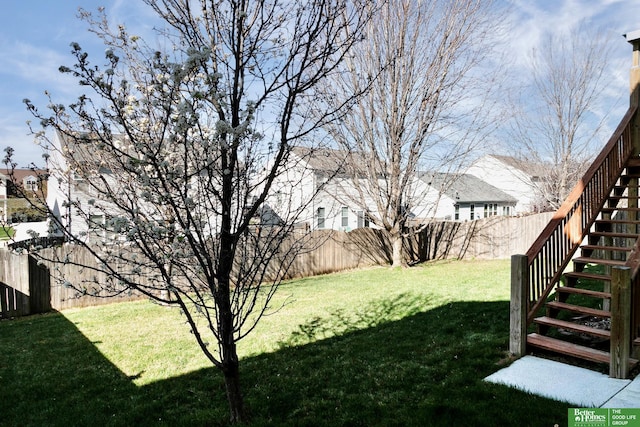 view of yard featuring stairway and a fenced backyard