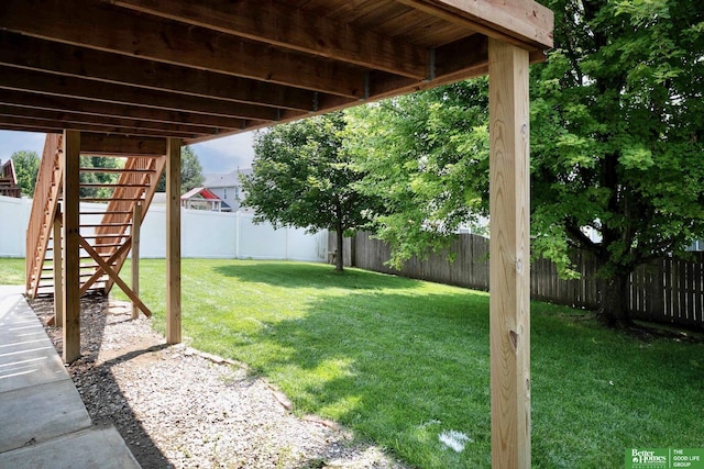 view of yard with stairway and a fenced backyard