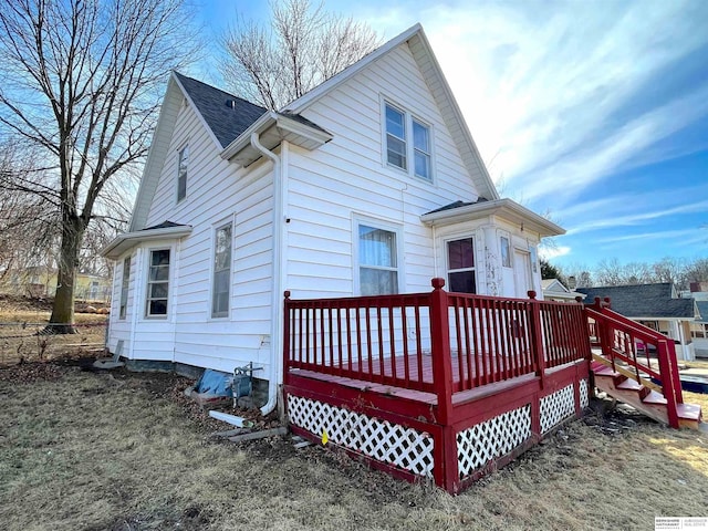 back of property with a wooden deck