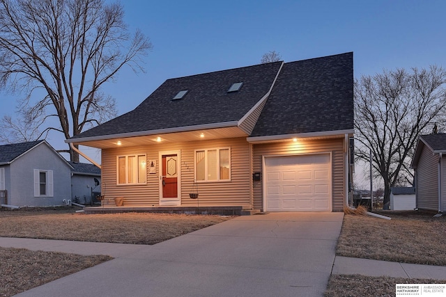 view of front of property with concrete driveway, an attached garage, and roof with shingles