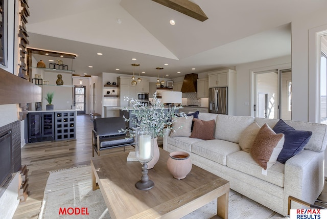 living room with recessed lighting, high vaulted ceiling, and light wood-style flooring