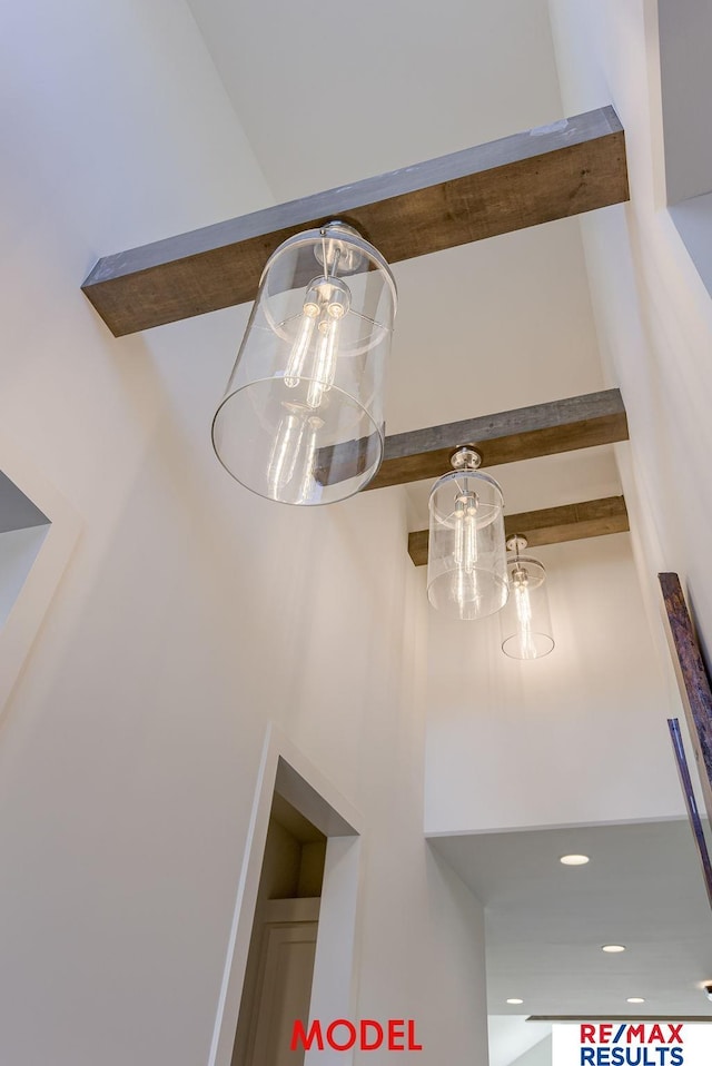 interior details with a notable chandelier and beamed ceiling