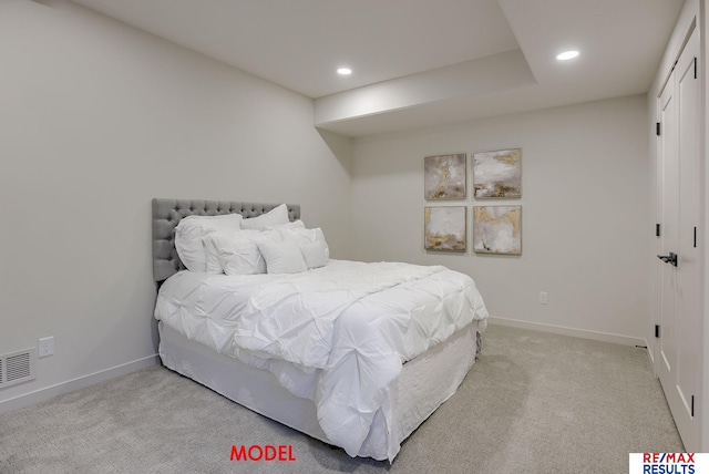 bedroom with recessed lighting, light colored carpet, and baseboards