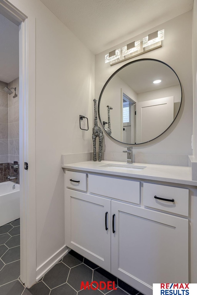 full bathroom featuring tile patterned flooring, bathing tub / shower combination, and vanity