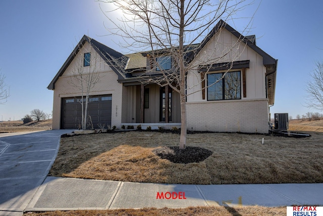 view of front facade with brick siding, central AC unit, concrete driveway, and a garage