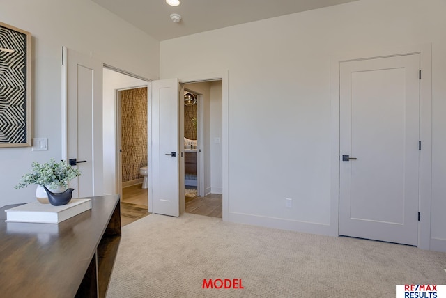 carpeted bedroom featuring baseboards