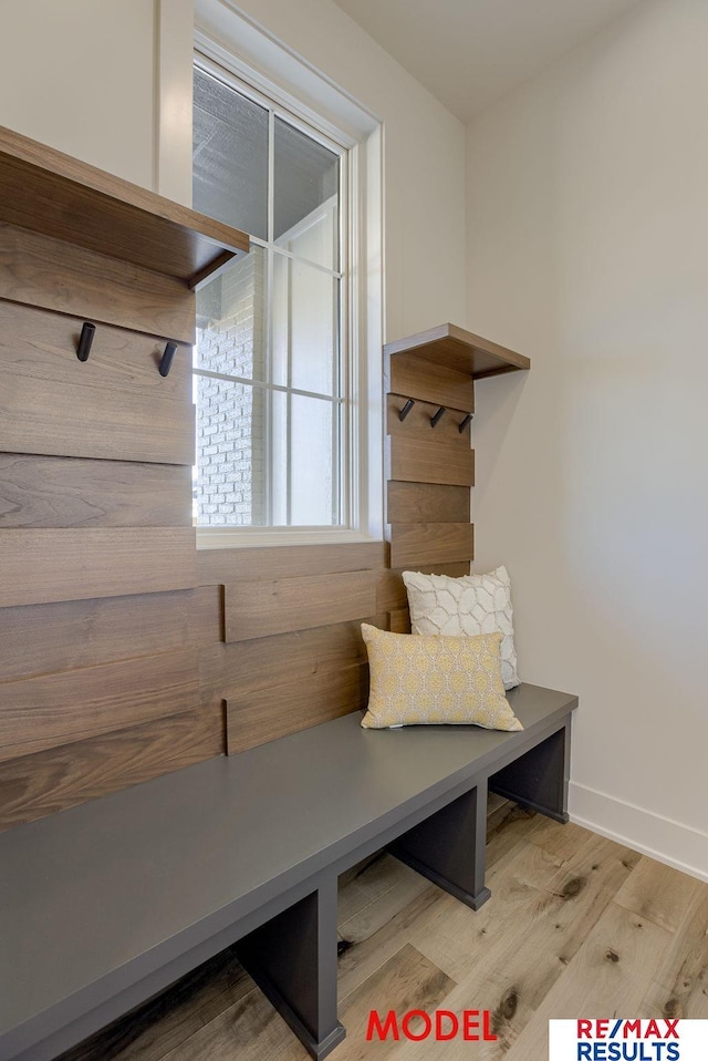 mudroom with baseboards and light wood-style flooring